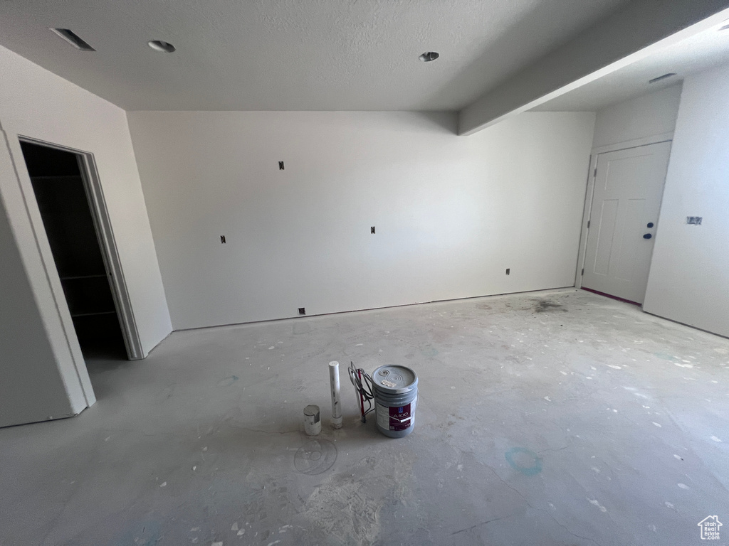 Empty room featuring a textured ceiling