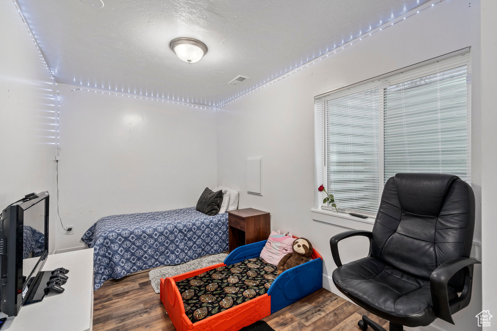 Bedroom featuring dark hardwood / wood-style floors