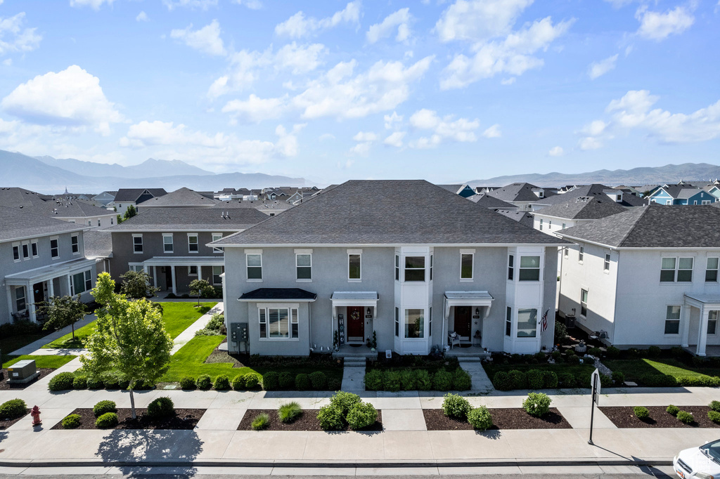 View of front of property with a front yard and a mountain view