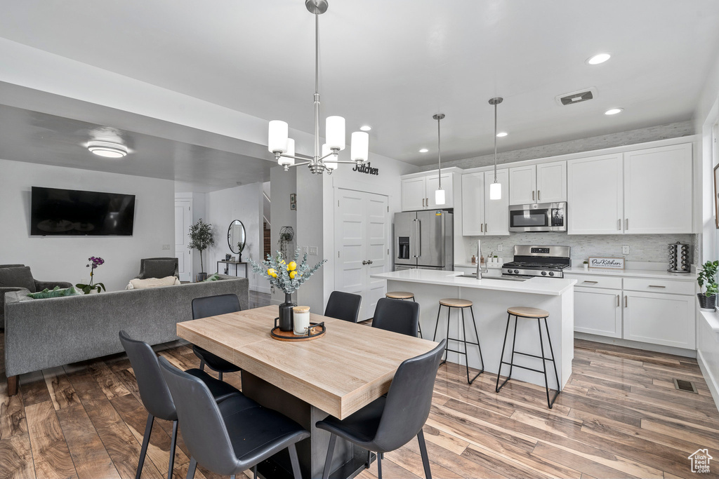 Dining space featuring dark hardwood / wood-style floors and an inviting chandelier