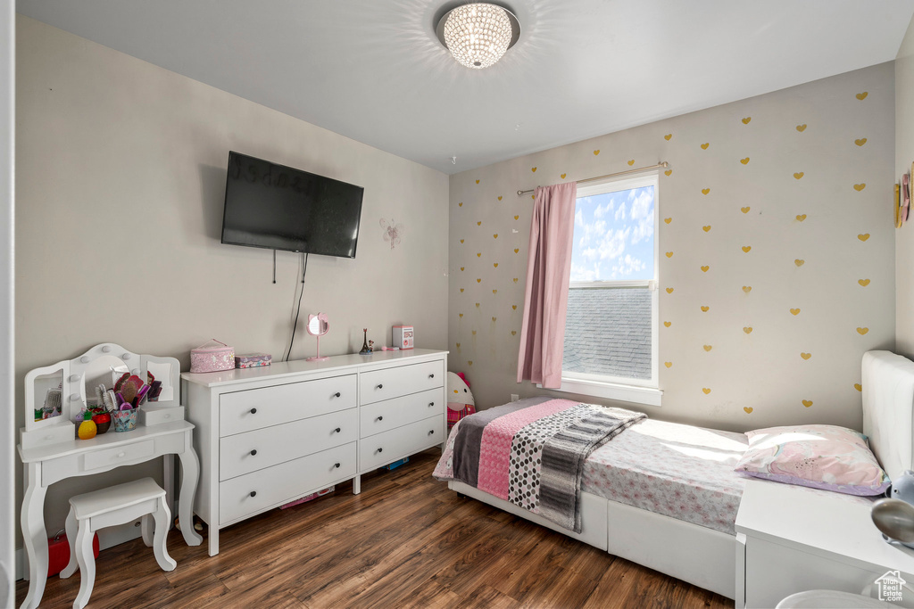 Bedroom with dark hardwood / wood-style floors