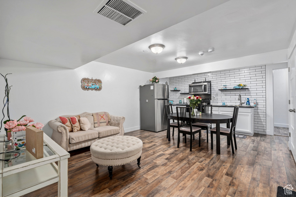 Living room featuring sink and hardwood / wood-style flooring