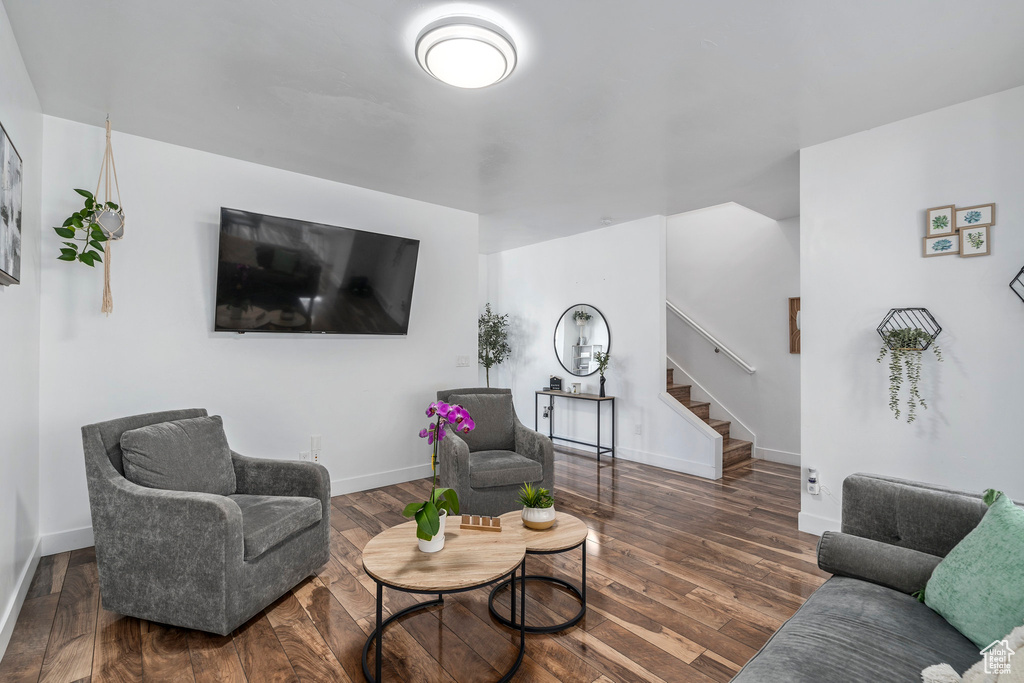 Living room with dark wood-type flooring