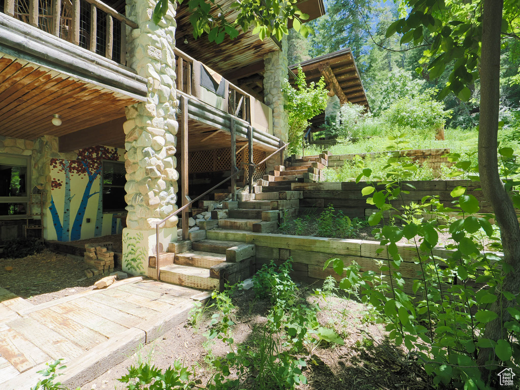 View of yard with a balcony