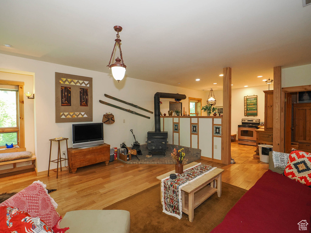 Living room with wood-type flooring and a wood stove