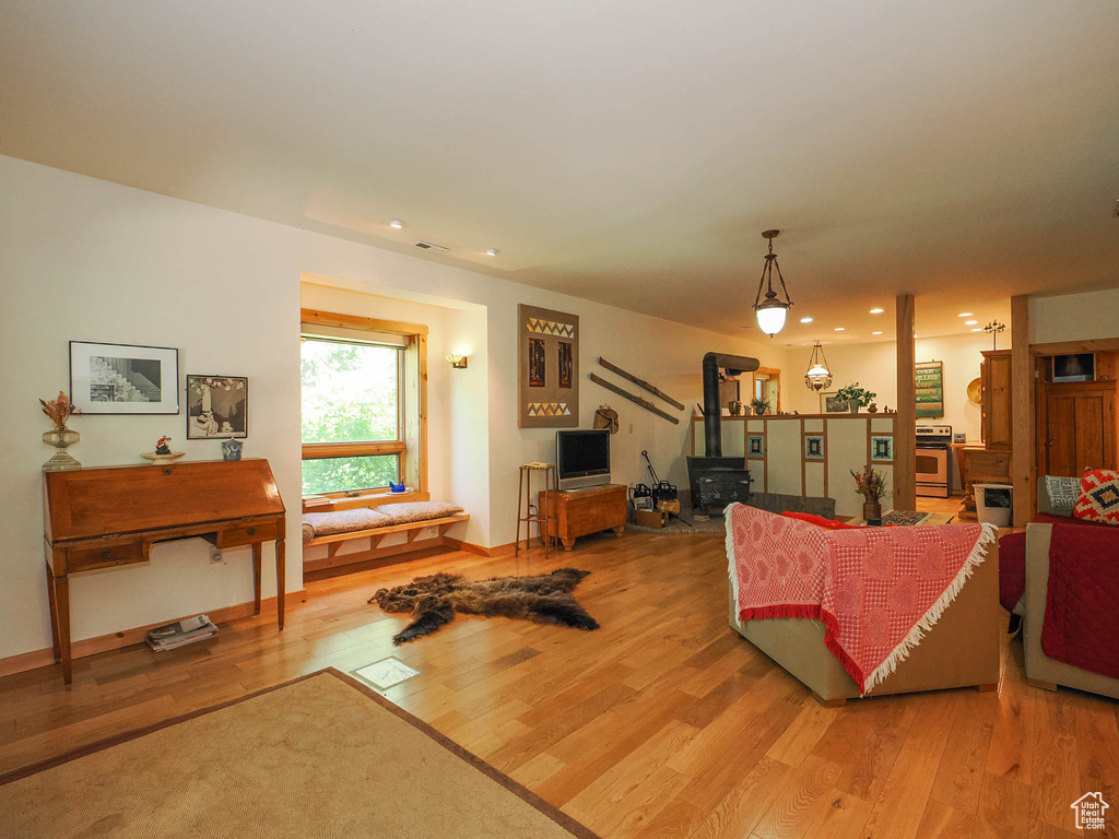 Living room with hardwood / wood-style flooring and a wood stove