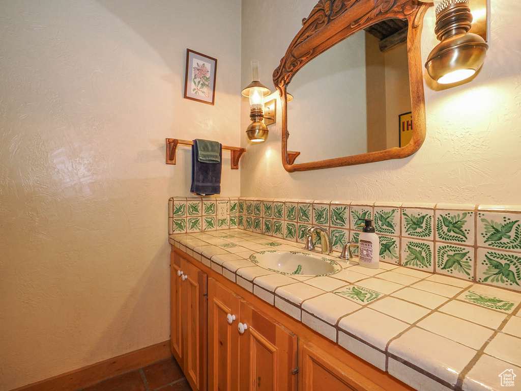 Bathroom featuring tile flooring and large vanity