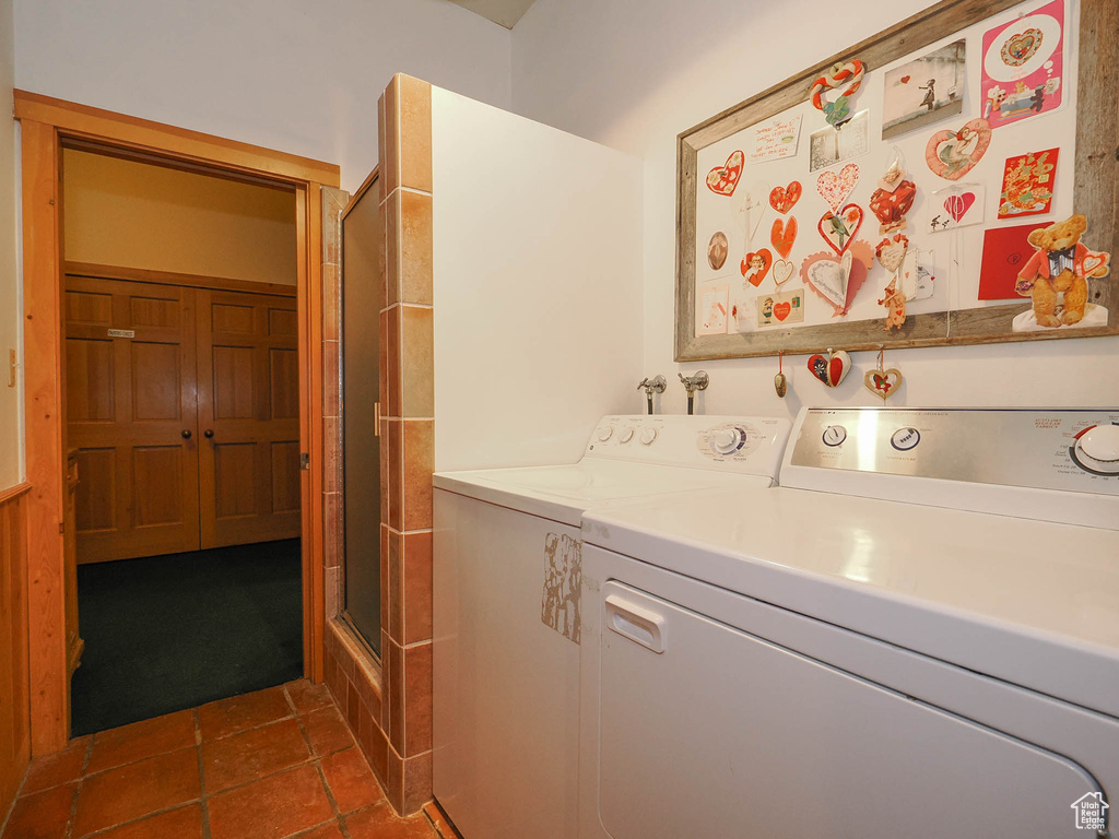 Washroom with hookup for a washing machine, dark carpet, and washing machine and clothes dryer