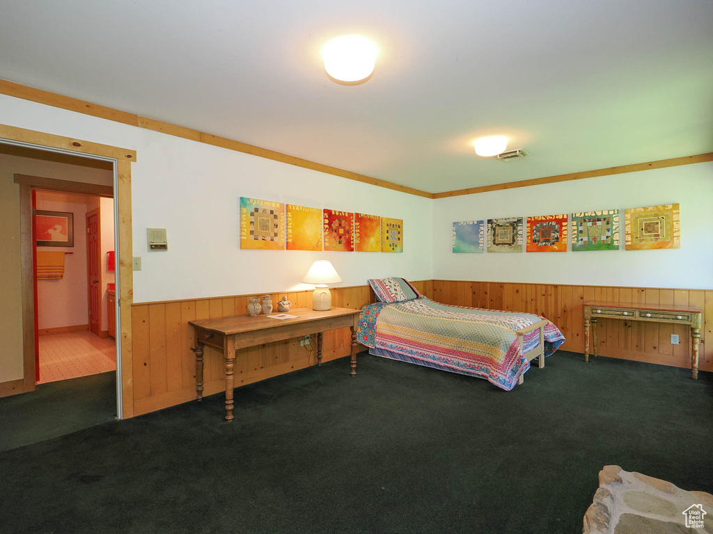 Carpeted bedroom with ornamental molding