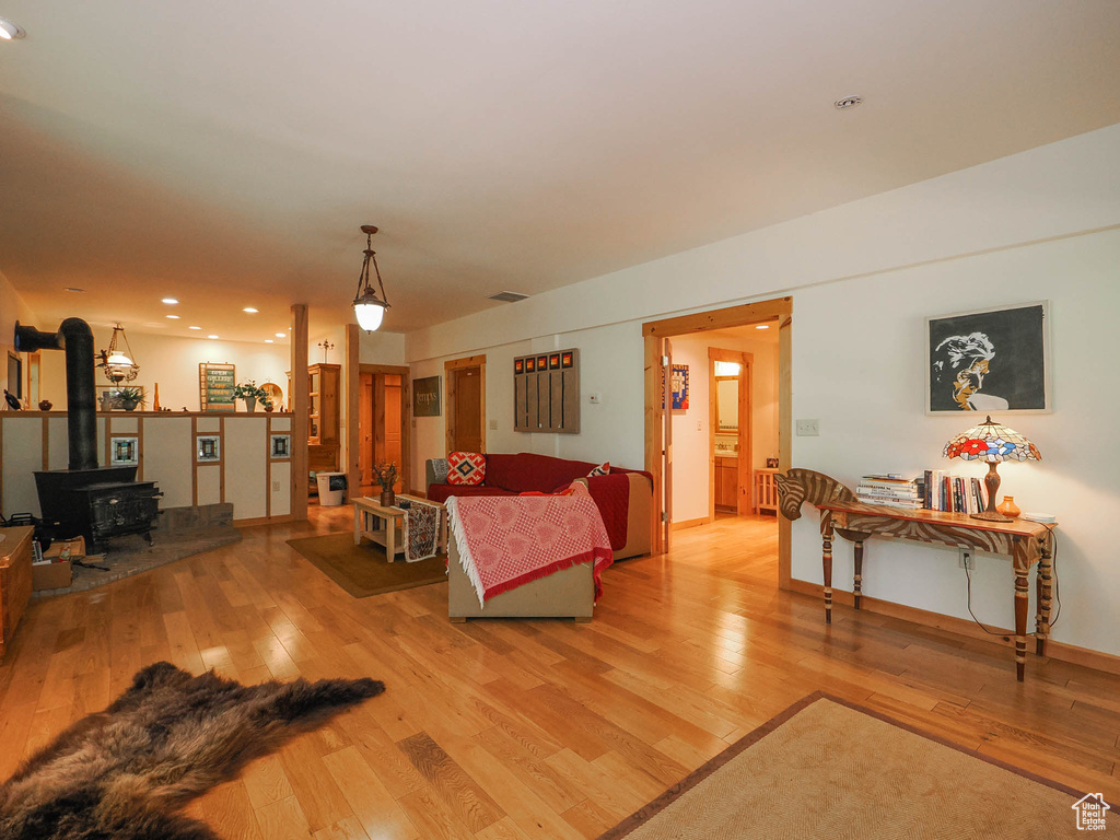 Living room featuring a wood stove and light hardwood / wood-style flooring