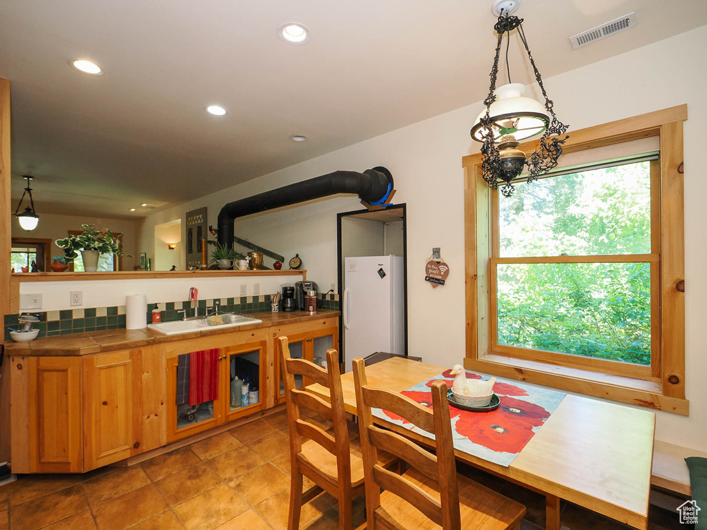 Tiled dining room with sink