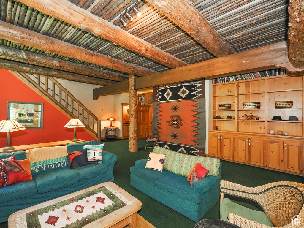 Carpeted living room with beamed ceiling