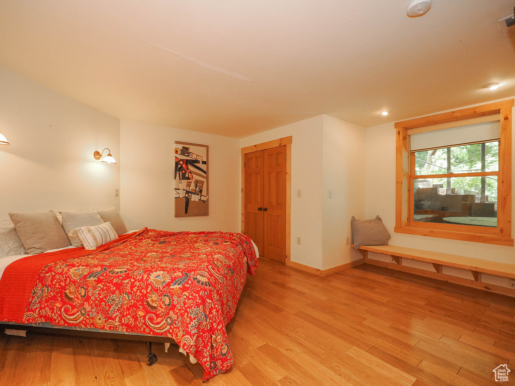 Bedroom with hardwood / wood-style flooring