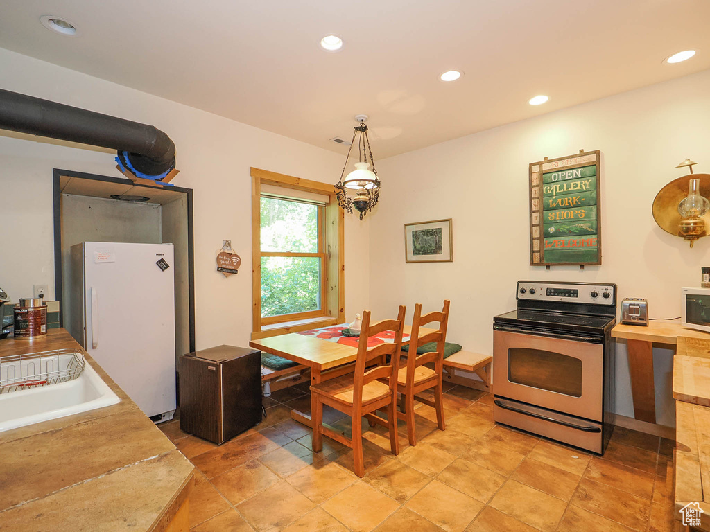 Tiled dining space with sink