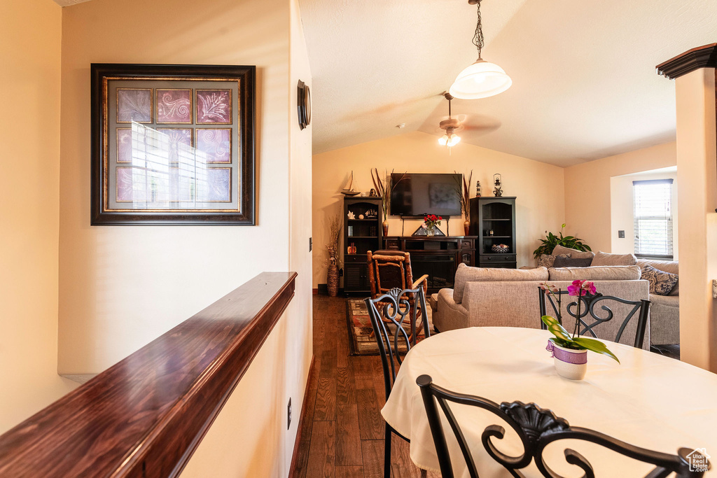 Dining area with vaulted ceiling, ceiling fan, and dark hardwood / wood-style floors