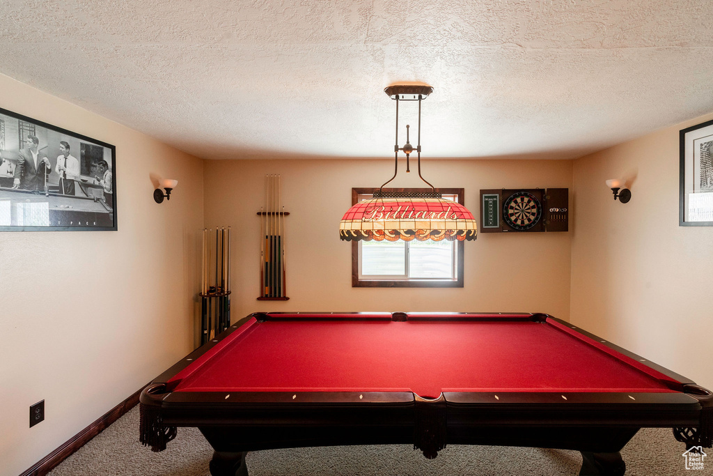 Game room featuring a textured ceiling, pool table, and carpet flooring