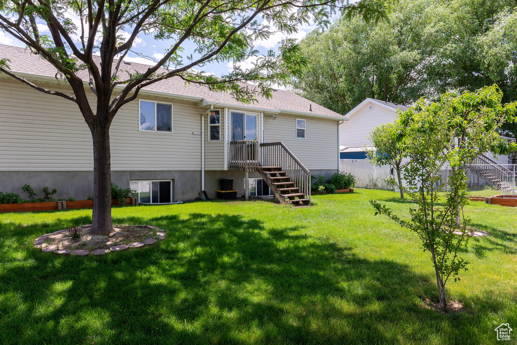 Rear view of house with a lawn