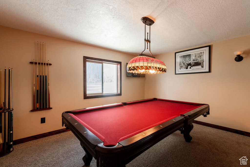 Rec room with dark carpet, billiards, and a textured ceiling