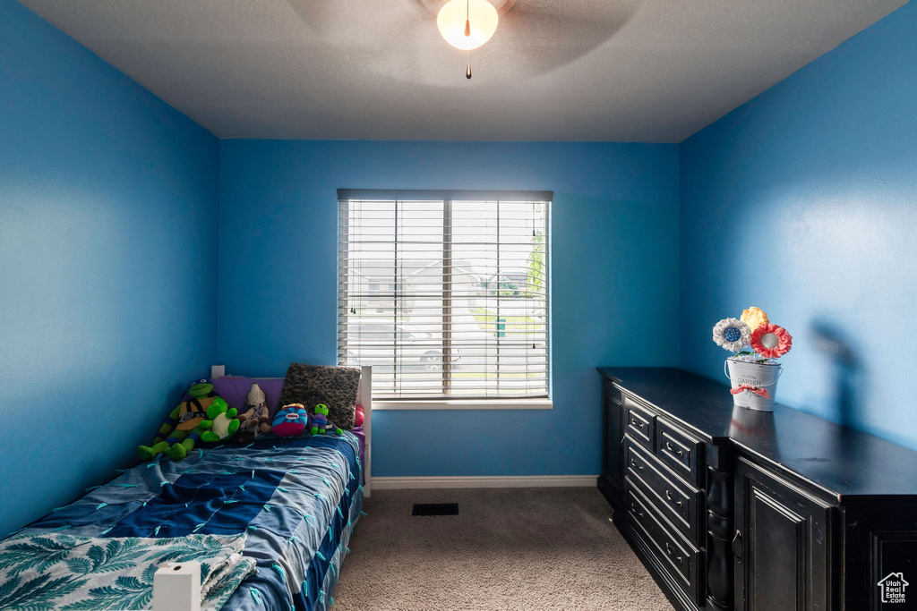 Carpeted bedroom with ceiling fan