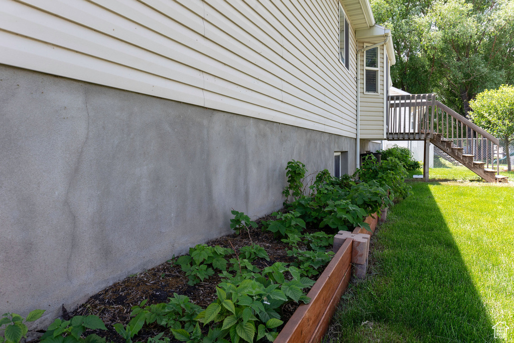 View of property exterior featuring a lawn