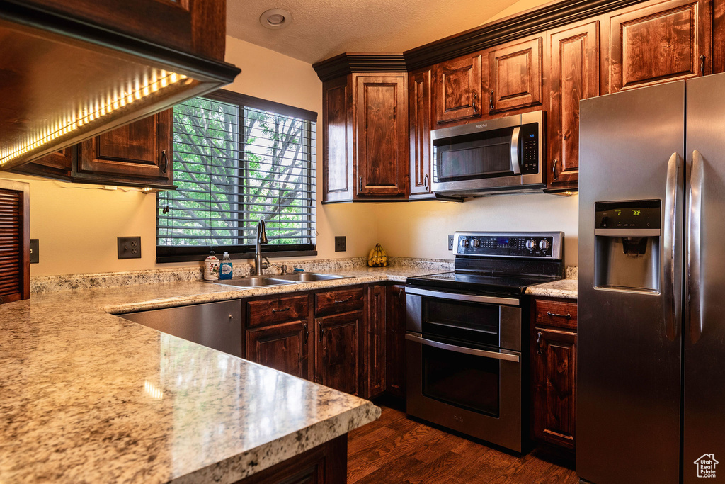 Kitchen featuring sink, dark hardwood / wood-style flooring, and appliances with stainless steel finishes