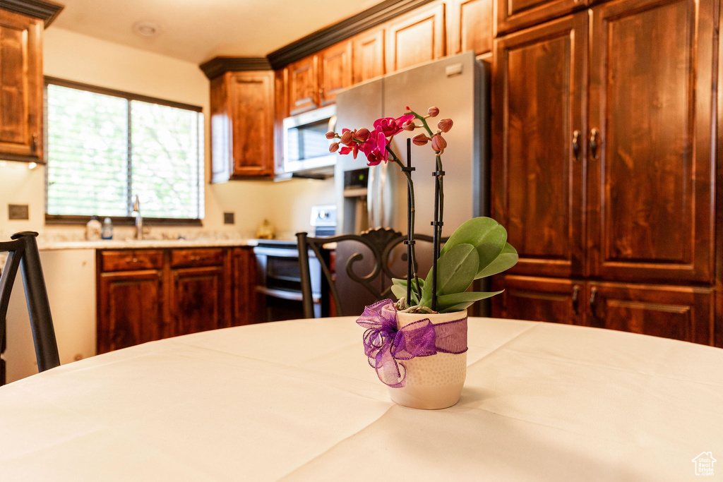 Kitchen with sink, stainless steel fridge, and range