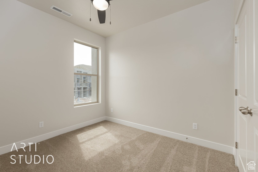 Spare room with carpet, ceiling fan, and a healthy amount of sunlight