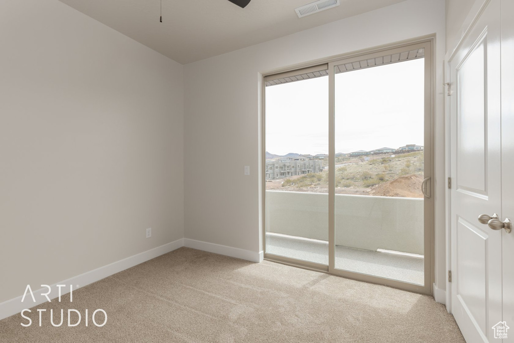 Empty room with carpet and ceiling fan