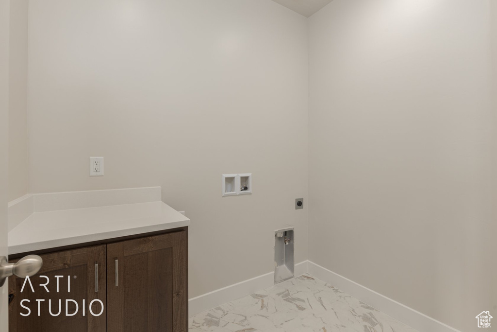 Laundry area featuring hookup for an electric dryer, hookup for a washing machine, and light tile floors