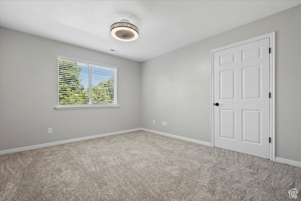 Unfurnished room featuring carpet flooring