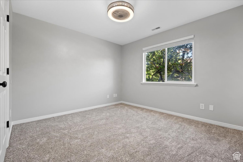 Spare room featuring carpet flooring