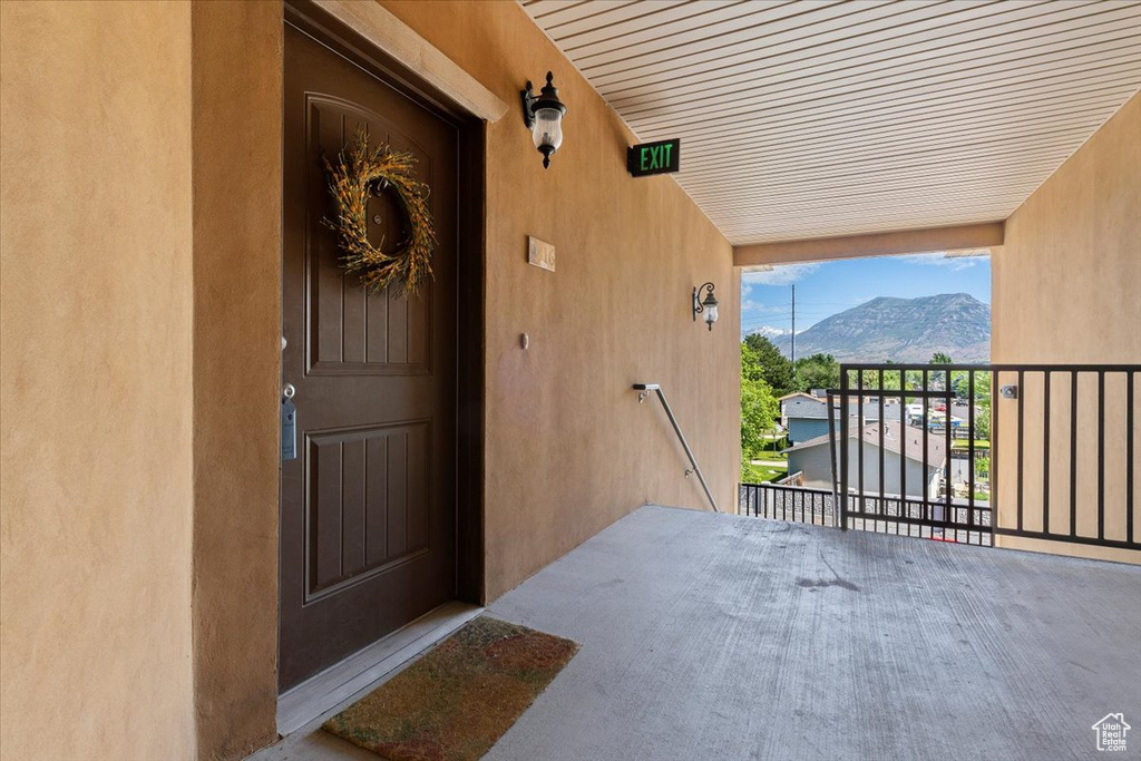 View of exterior entry featuring a balcony and a mountain view