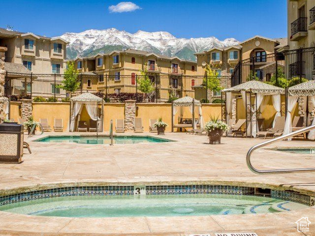 View of pool featuring a mountain view and a patio