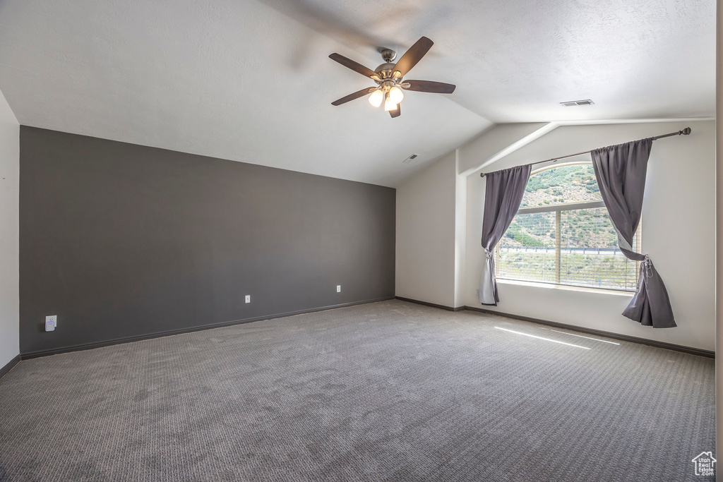 Bonus room featuring ceiling fan, vaulted ceiling, and carpet floors