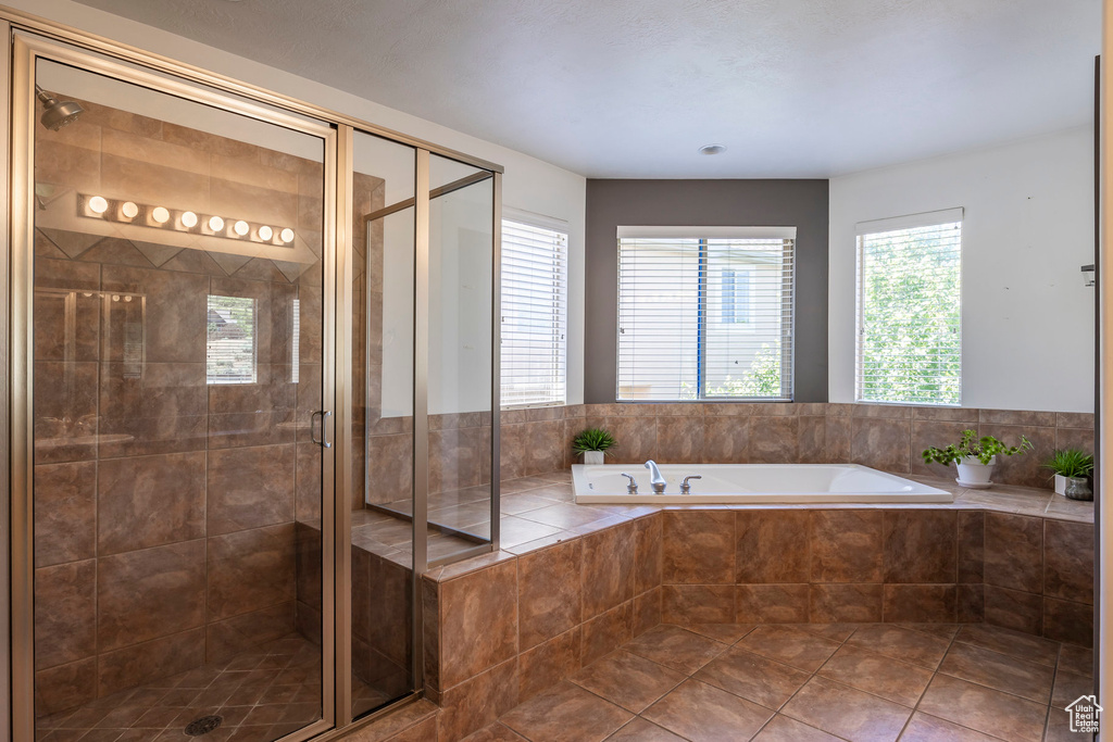 Bathroom with tile patterned floors and independent shower and bath