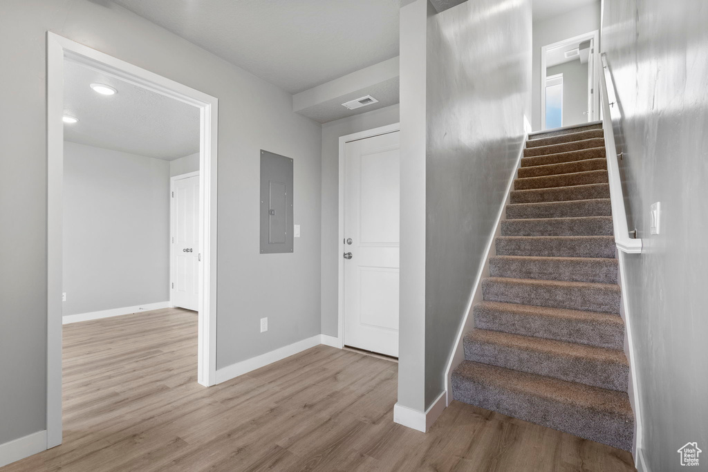 Stairway featuring hardwood / wood-style floors