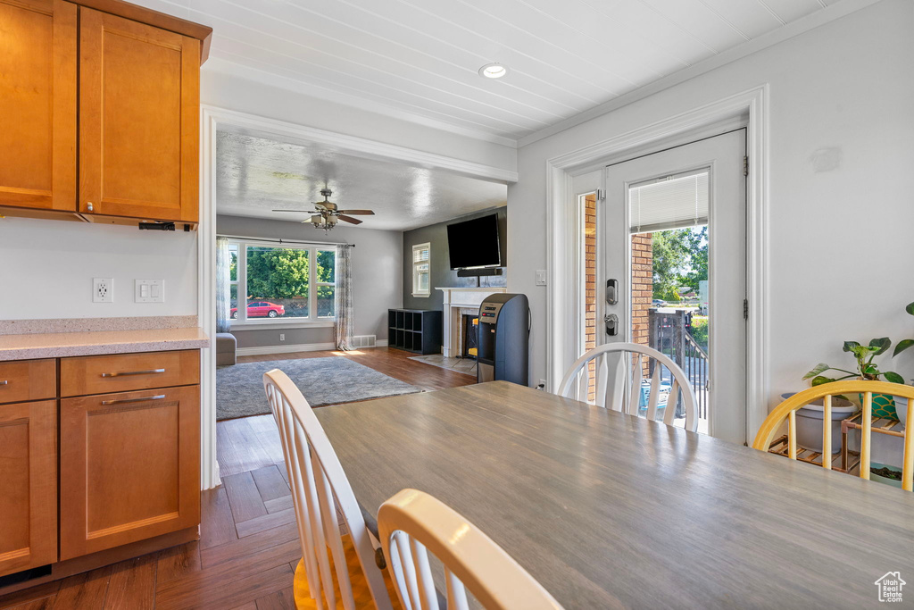 Dining space with ceiling fan and crown molding