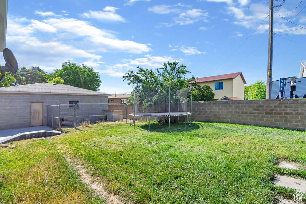 View of yard with a trampoline