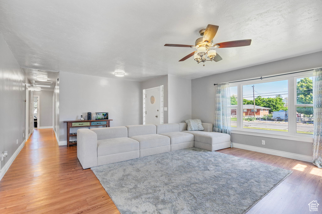 Living room featuring hardwood / wood-style floors and ceiling fan