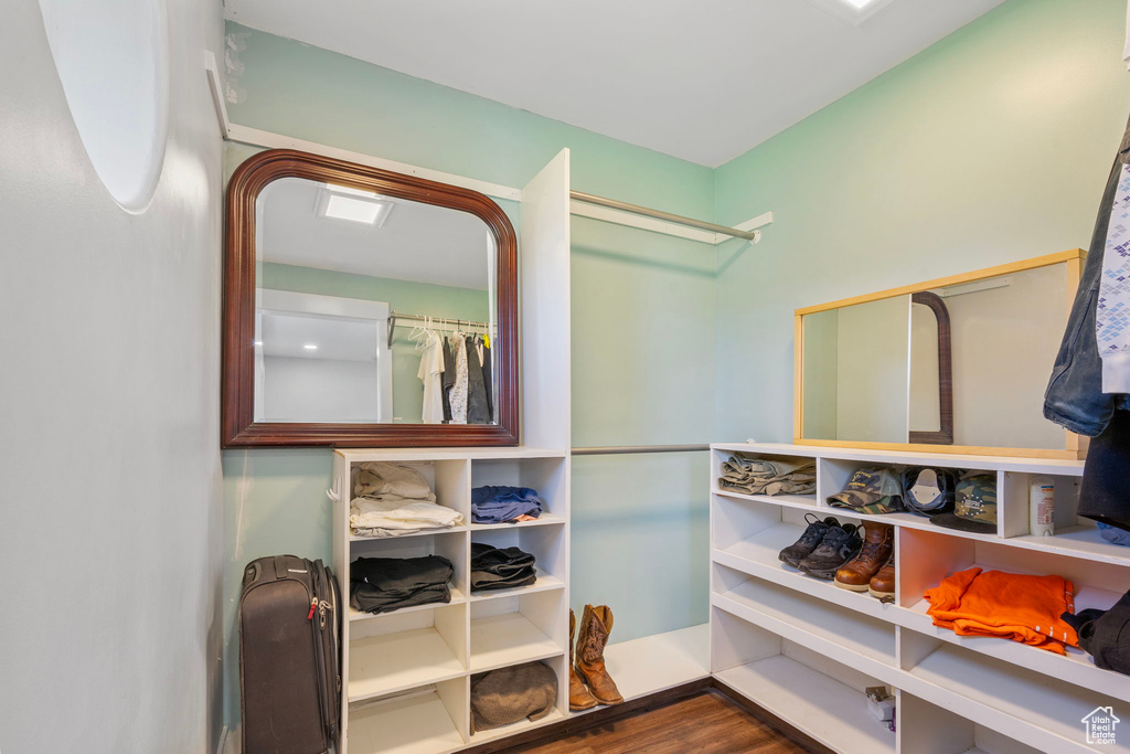 Spacious closet with hardwood / wood-style floors