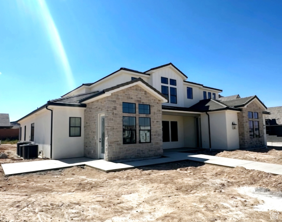 View of front of property featuring a patio area and cooling unit