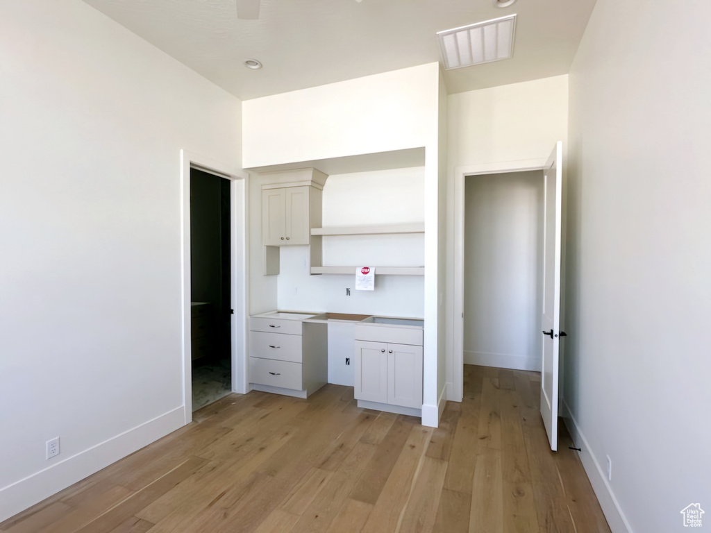 Interior space with light wood-type flooring and built in desk