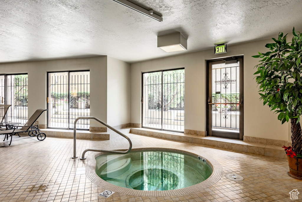 View of swimming pool with an indoor in ground hot tub