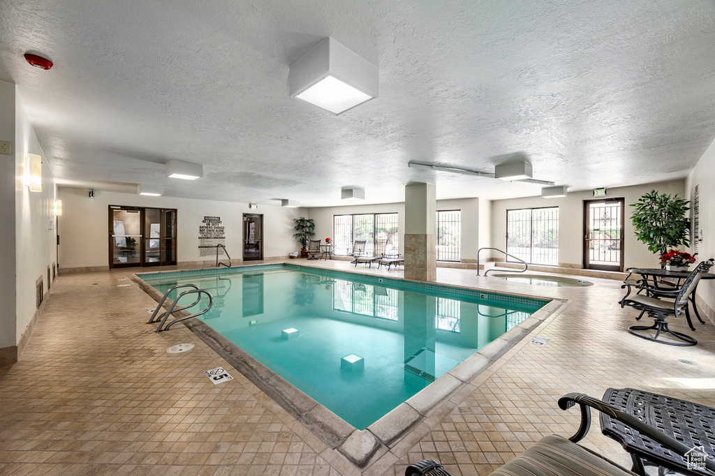 View of swimming pool featuring an indoor hot tub