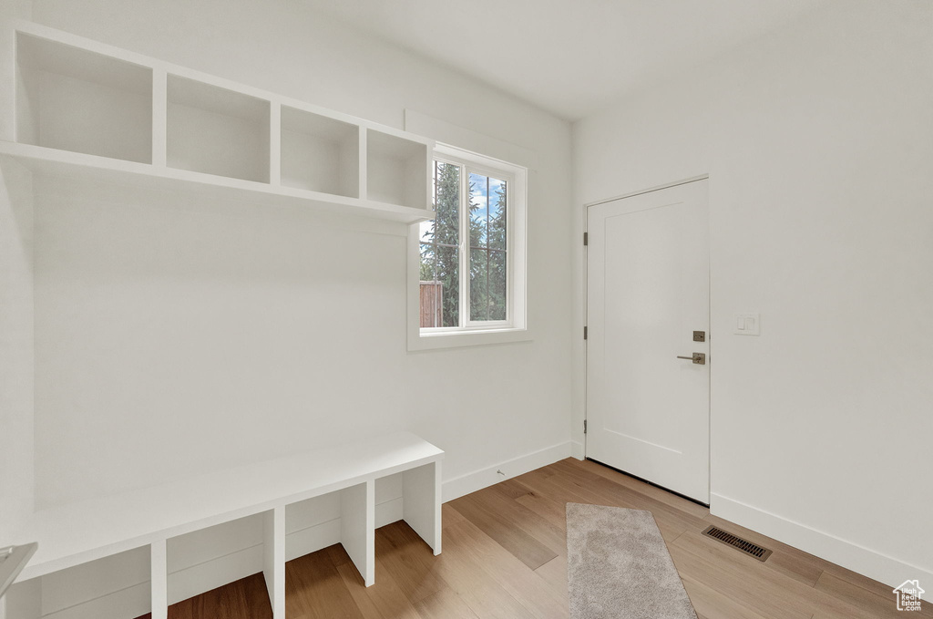 Mudroom with light hardwood / wood-style floors