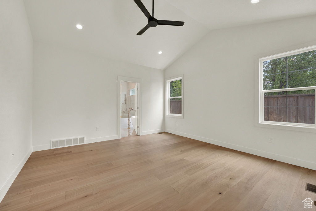 Spare room with ceiling fan, light hardwood / wood-style flooring, and vaulted ceiling