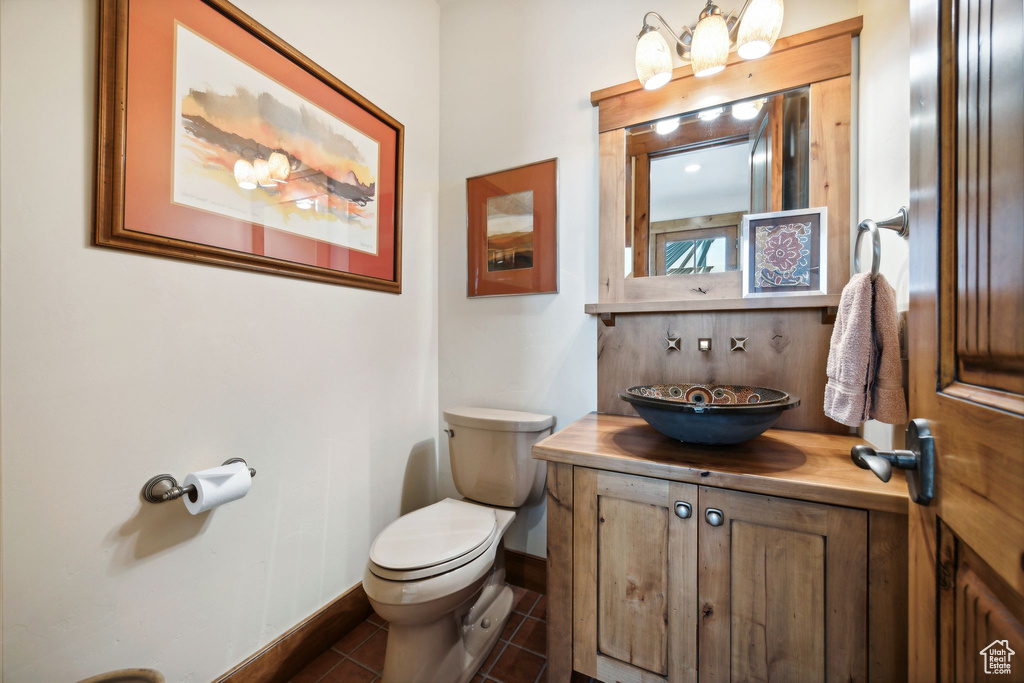 Bathroom featuring tile floors, toilet, and vanity