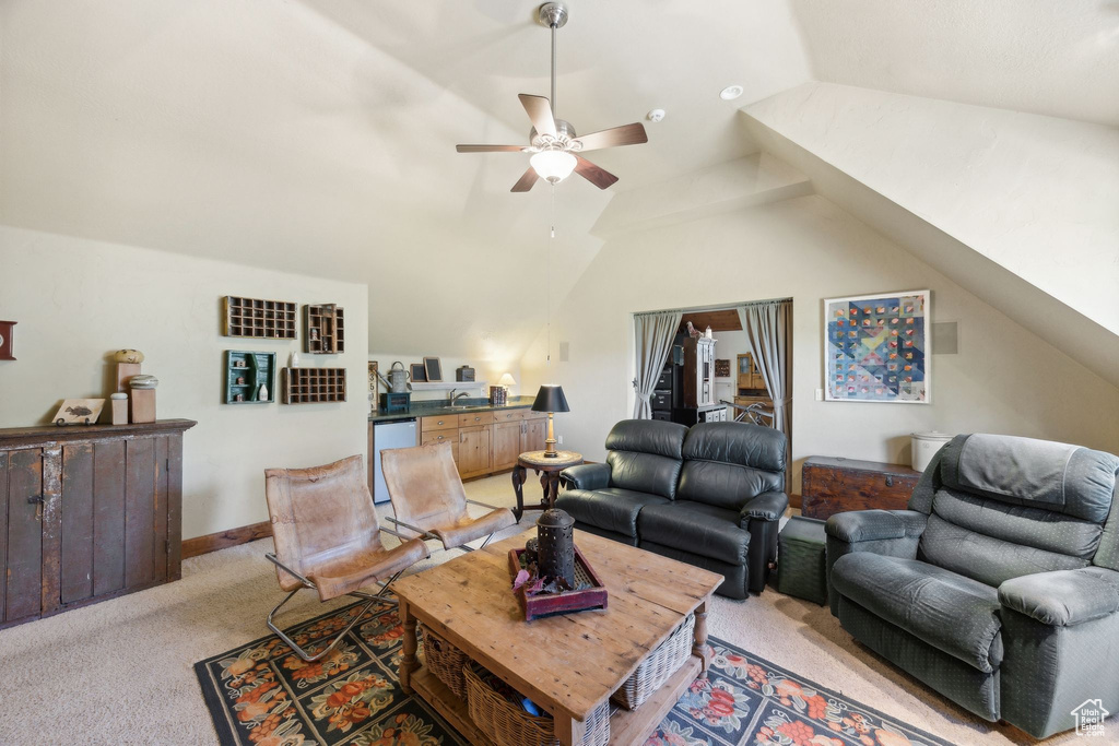 Carpeted living room featuring vaulted ceiling and ceiling fan