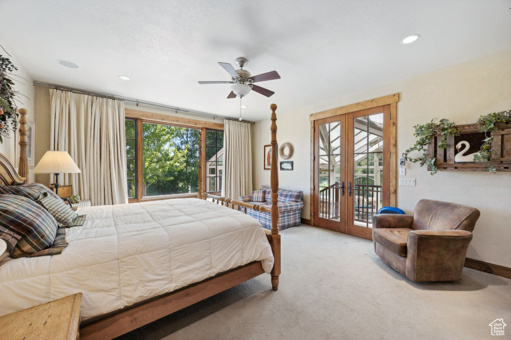 Bedroom with carpet flooring, ceiling fan, french doors, and access to outside