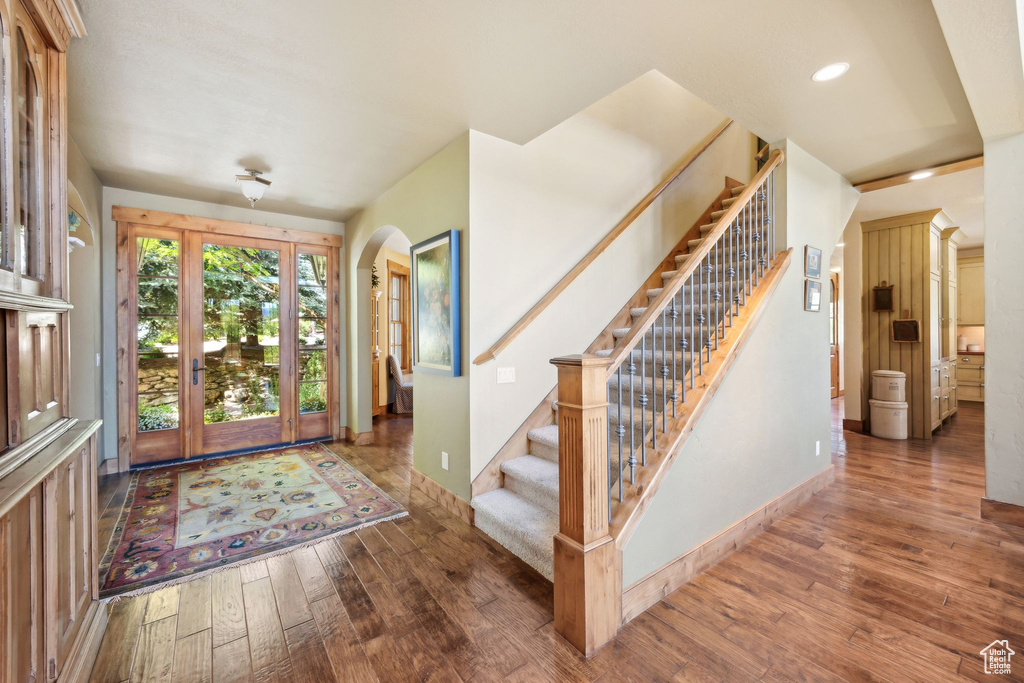 Entryway with hardwood / wood-style flooring and french doors